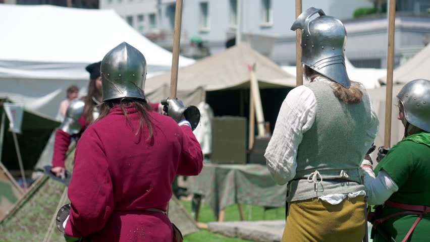 Guardians of the Past, Soldiers Poised with Spears at Reenactment Festival. Soldiers with steel helmets at Historical Fair on Standby