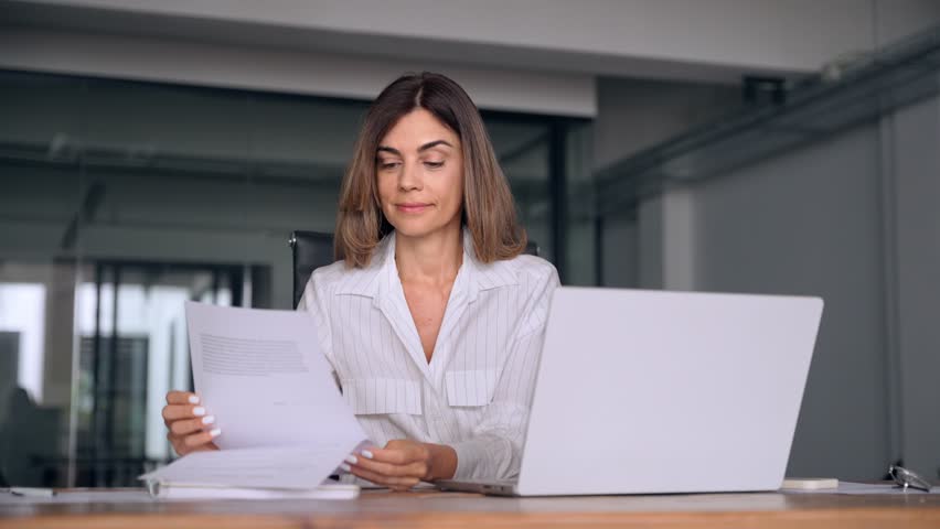 40s mid age European business woman CEO using laptop application for work sitting at table workspace in office. Smiling Latin Hispanic mature adult professional businesswoman using pc digital computer Royalty-Free Stock Footage #1107342091