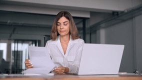 40s mid age European business woman CEO using laptop application for work sitting at table workspace in office. Smiling Latin Hispanic mature adult professional businesswoman using pc digital computer - Powered by Shutterstock - Get 15% off with code: PIKWIZARD15