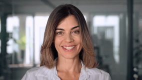 Headshot close up portrait of latin hispanic confident mature good looking middle age leader, ceo female businesswoman on blur office background. Gorgeous beautiful business woman smiling at camera. - Powered by Shutterstock - Get 15% off with code: PIKWIZARD15