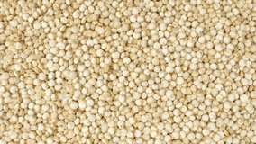 White quinoa is a highly nutritious grain-like seed packed with protein, fiber, vitamins, and minerals. It aids in muscle repair, supports digestion, and promotes overall well-being. Macro footage.
