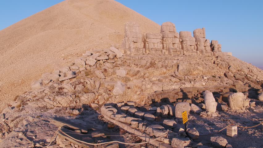 Zoom in front view Statues wit heads on top of the Nemrut Mountain in Adiyaman, Turkey. Morning sunrise east side Nemrut Dagi Royalty-Free Stock Footage #1107355469