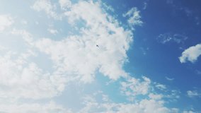 Airplane flying over blue sky with fluffy clouds. Vertical video. Big passenger airplane flies through white clouds