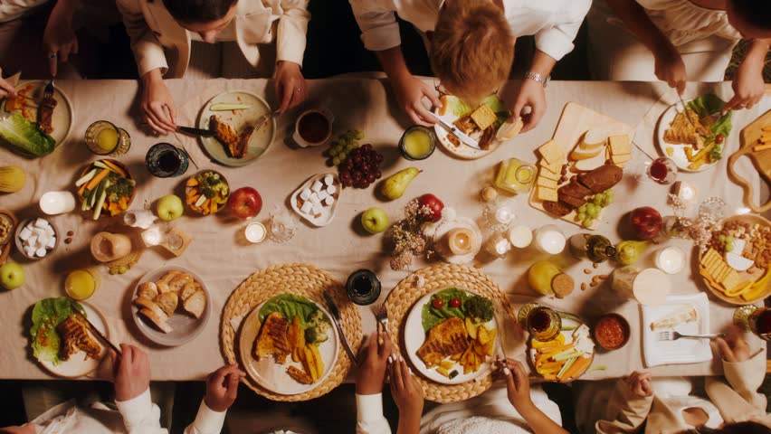 Top view of a beautifully laid festive table. Guests eat and talk while sitting at the table outdoor Royalty-Free Stock Footage #1107368173