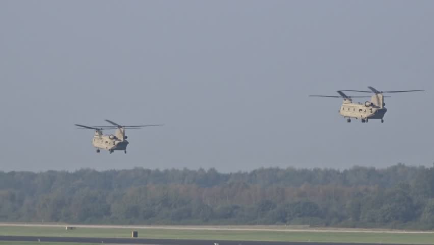 Army Air Force Military Heavy Helicopters approaching air base for landing