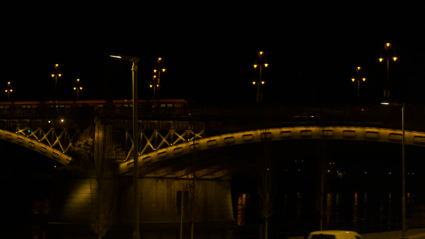 Beautiful illuminated bridge in old Europe. A view of chained Budapest bridge with street illumination during night time.