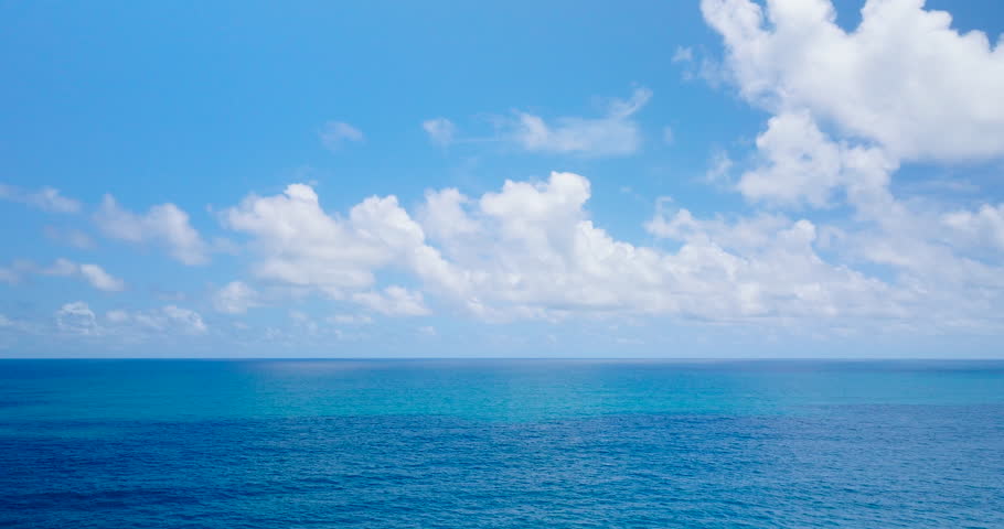 A short film of drones flying over the sea off the coast with blue water and clear skies. Filmed with high quality film cameras. DCI 4K ProRes422