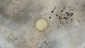 Rolling out the dough for a pie, galette or cookies through parchment paper with a rolling pin, top view lifestyle video - Powered by Shutterstock - Get 15% off with code: PIKWIZARD15