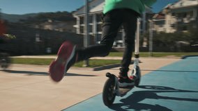 Girl riding kick scooter on playground. 4k video footage UHD 3840x2160
