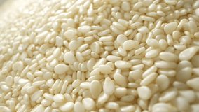 White sesame seeds are commonly used as a garnish and ingredient in various dishes. They are sprinkled on top of bread, buns, and other baked goods to add texture and enhance the visual appeal. 
