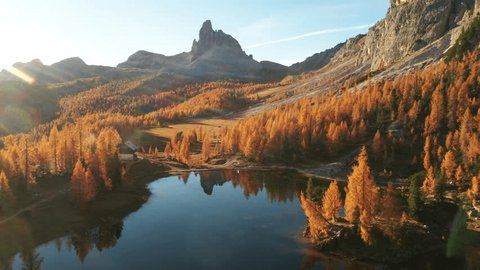 Drone flyght over Federa Lake in sunrise time. Autumn mountains landscape with Lago di Federa and bright orange larches in the Dolomite Apls, Cortina D'Ampezzo, South Tyrol, Dolomites, Italy 스톡 비디오