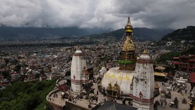 Aerial view of the popular Tibetan pilgrimage temple Swayambhu in Kathmandu city. Drone flight with a view of Swayambhunath in Nepal. Cinematic 4k footage.