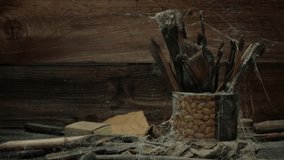 OLD ARTIST'S BRUSHES COVERED IN COBWEBS - IN 4K.  OLD, LONG FORGOTTEN BRUSHES & SCULPTURES TOOLS SIT IN A PEANUT CAN COVERED IN COBWEBS.  IN 4K. - Powered by Shutterstock - Get 15% off with code: PIKWIZARD15