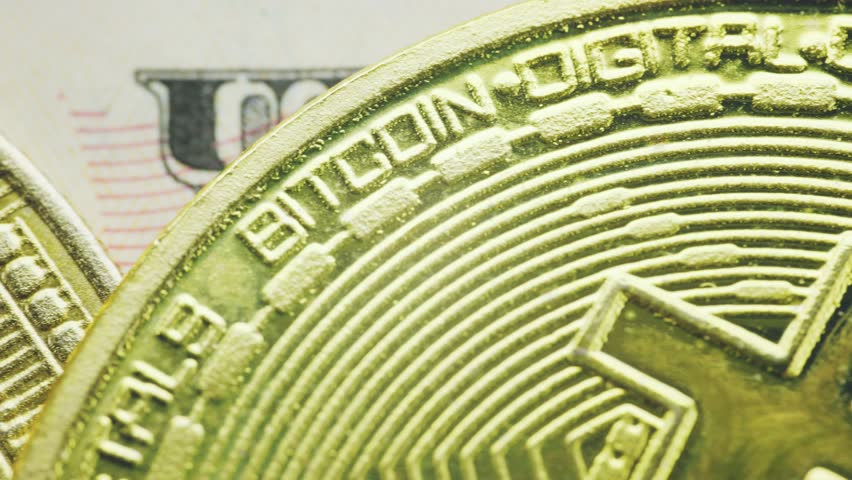 bitcoin coins lie on a dollar bill close-up