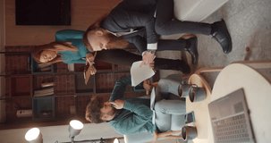 Three business people working together on a business deal, vertical video, teal and orange, trucking
