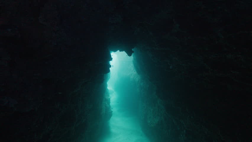 Cave diving. Camera slowly moves in the cave underwater towards the exit Royalty-Free Stock Footage #1107405645