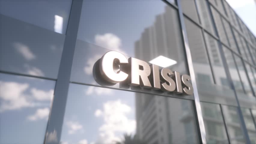 Crisis sign on glass building. Mirrored sky and city on modern facade. Business and finance concept