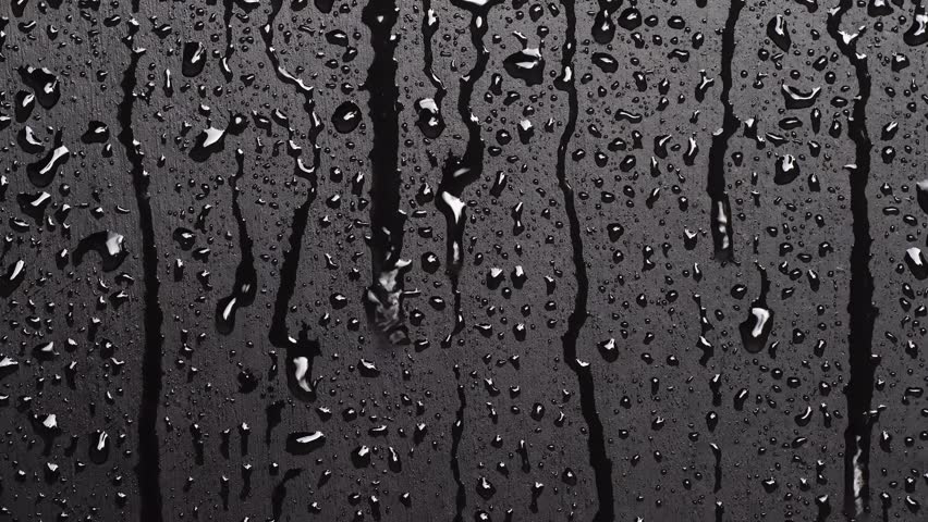 Water droplets on the black glass.	