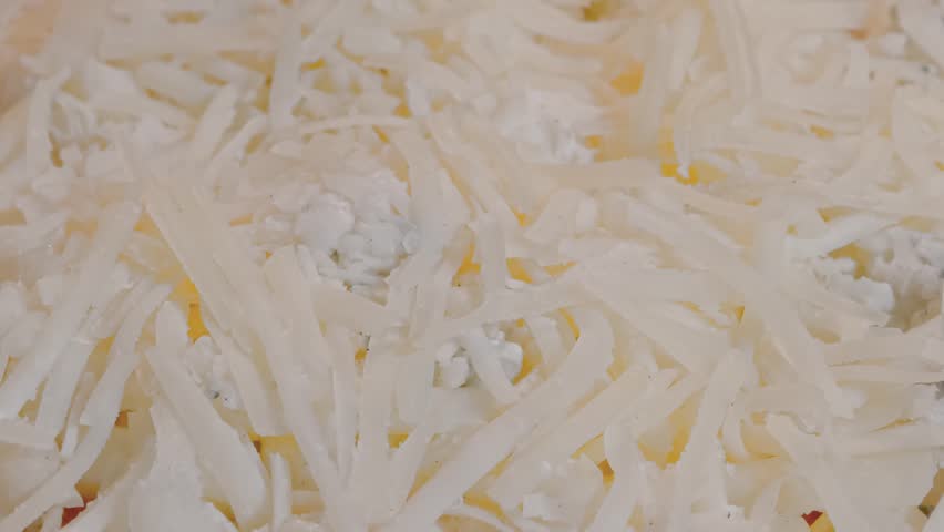 Macro, close up - cheese on pizza melting in electric oven - timelapse. Italian cuisine, homemade bakery, fast food, cooking and time lapse concept