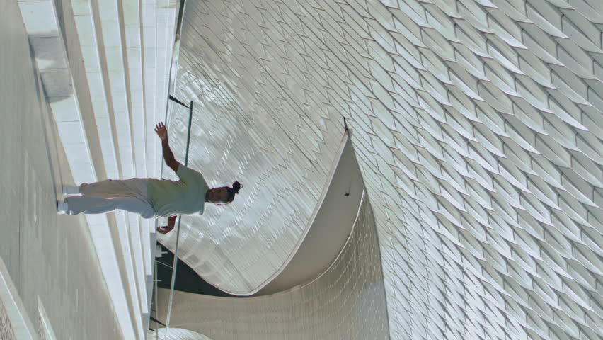 Fashion man training stairs alone vertical angel. Modern dancer performing contemporary moves at concrete stadium. African american graceful performer showing feelings open space place. Youth culture 