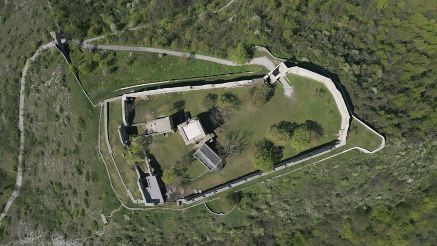 Aerial view of ruined castle on hill, city Hainburg an der Donau and Danube river in Austria, 4k