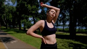 Portrait of exhausted charming athletic fitness middle aged woman jogger catching a breath , wiping sweats with hand from forehead while taking a break during intense running workout outdoors. - Powered by Shutterstock - Get 15% off with code: PIKWIZARD15