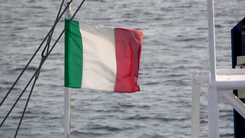 Italian flag flies in violent storm on small boat on coast of Sardinia Royalty-Free Stock Footage #1107424843