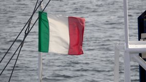 Italian flag flies in violent storm on small boat on coast of Sardinia - Powered by Shutterstock - Get 15% off with code: PIKWIZARD15