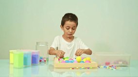 
A cute boy happily played the multicolored beads in the white room.
high quality video 4K. studio shot.
Playing with colorful beads is a great way for children to learn. 	
colorful beads background