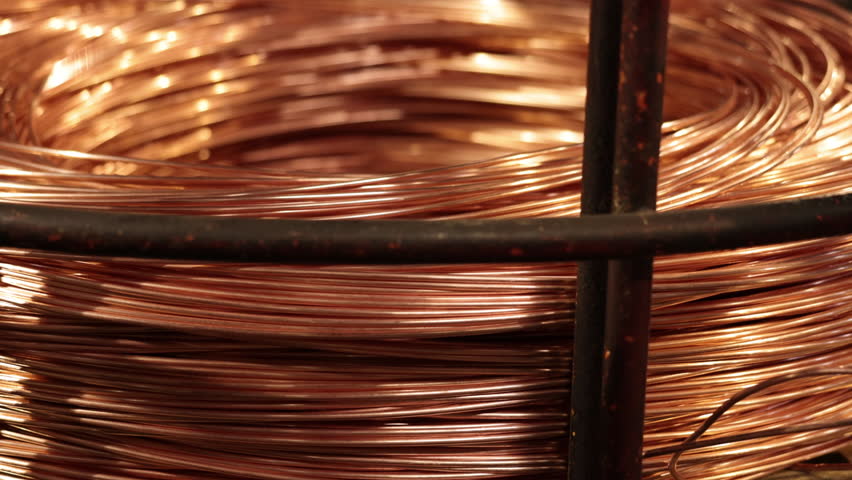Wire coiling, cable making, copper industry. In industrial setting, copper wire is made and formed into coil, contributing to cable manufacturing processes. Royalty-Free Stock Footage #1107426747