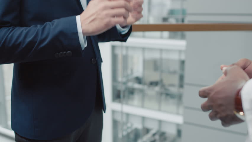 Cropped shot of businessman and doctors handshake on occasion of deal, hall of modern clinic with panoramic windows Royalty-Free Stock Footage #1107434921