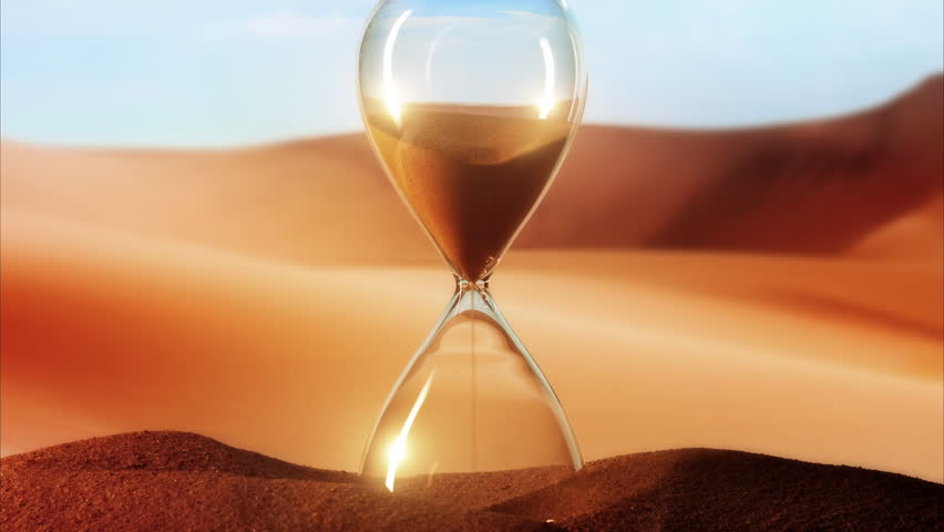 Hourglass clock on sand red desert dunes background time-lapse shot Royalty-Free Stock Footage #1107437107
