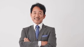 Asian middle aged businessman smiling in white background - Powered by Shutterstock - Get 15% off with code: PIKWIZARD15