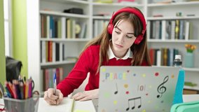 Young hispanic woman student having online lesson showing notebook at library university
