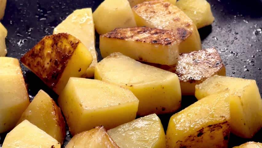 Diced potatoes frying on a pan, chips cooking process for recipe, homemade comfort food and dinner preparation, slow motion video Royalty-Free Stock Footage #1107449071