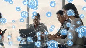 Animation of network of icons over team of diverse colleagues using electronic devices at office. Global networking and business technology concept - Powered by Shutterstock - Get 15% off with code: PIKWIZARD15