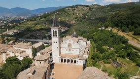 Duomo of Spoleto Cathedral and surrounding landscape in Umbria, Italy. Aerial circling view