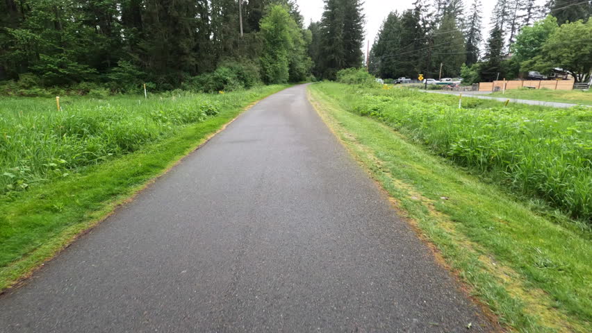 Point of view of bicyclist riding along the Centennial Rail Trail in Snohomish Washington
