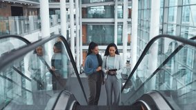 Escalator, office and business women on tablet on commute, travel and arrival at work. Modern building, professional team and female people talking on electric stairs for discussion, project and job - Powered by Shutterstock - Get 15% off with code: PIKWIZARD15