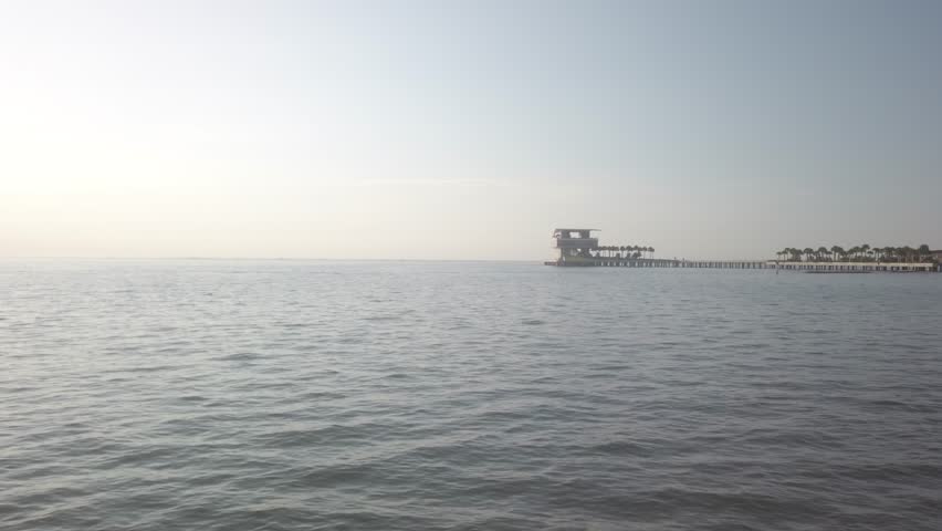 St. Petersburg Vinoy Basin Looking east towards Tampa Bay early morning sun towards pier. Golden hour picture. Blue sky and calm waters.