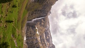 Time Lapse heart of waterfall in the Cirque de Gavarnie in south of France.  Gavarnie falls with water cascading down the cliffs and rocks. Vertical, vertical video background.