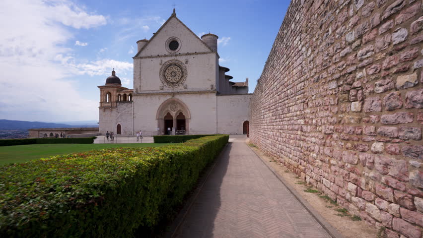 Tracking towards the facade of the beautiful upper church of the Basilica of Saint Francis of Assisi, in Umbria, Italy.