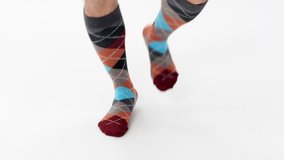 Checkered long men's socks. The male model runs briskly where he is. Warm-ups, cardio. White Studio. A series of e-commerce model socks videos. Catalog.