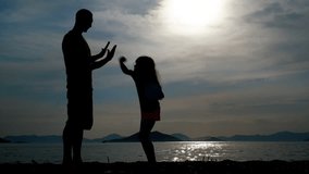 Father teaches daughter to box. Silhouette of a father training his daughter on the seashore. - Powered by Shutterstock - Get 15% off with code: PIKWIZARD15
