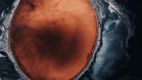 Top down waves opening orange paint ink texture with paint ink underwater - Powered by Shutterstock - Get 15% off with code: PIKWIZARD15