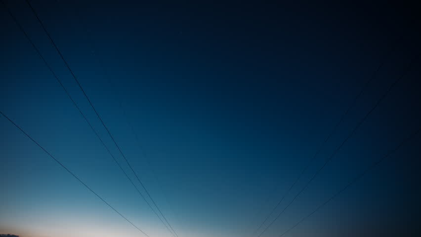 Daybreak Sky. Star Trails On Night Sky Background. Dawn Is Coming. 4k Time Lapse Night Starry Sky. Amazing Stars Effects In Sky. Soft Blue-orange-pink Colours. Trails Of Stars Above Power Line. Large