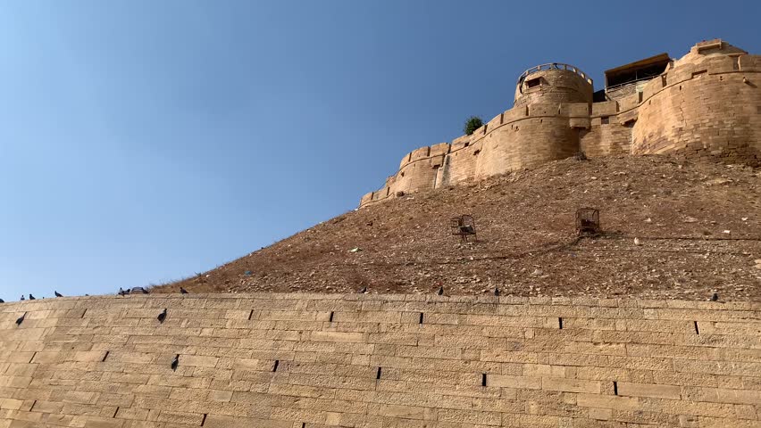 A shot of the fort wall with buildings at Jaisalmer Fort and houses inside the fort wall in the desert of Jaisalmer in Rajasthan, India