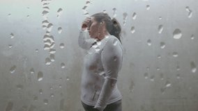 Animation of drops of rain over plus size caucasian woman exercising in city. Sports, active lifestyle, urban living and happiness concept digitally generated video.