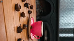 Pink coffee mug and chestnuts on wooden table in front of fireplace. the person who takes one of the chestnuts - Powered by Shutterstock - Get 15% off with code: PIKWIZARD15