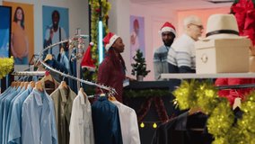 Senior woman browsing through blazer racks in clothing shop men section, looking for perfect Christmas gift for son during winter holiday season. Client in fashion boutique checking clothes - Powered by Shutterstock - Get 15% off with code: PIKWIZARD15